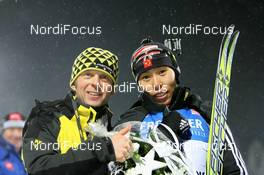 06.12.2008, Oestersund, Sweden (SWE): Michael Grossegger (AUT), Fischer racing service and Chunli Wang (CHN), Fischer, Salomon, Swix, adidas   - IBU world cup biathlon, sprint women, Oestersund (SWE). www.nordicfocus.com. © Manzoni/NordicFocus. Every downloaded picture is fee-liable.