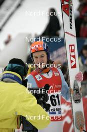 13.01.2008, Val di Fiemme, Italy (ITA): Tom Hilde (NOR) and the camera-girl - FIS world cup ski jumping, individual HS134, Val di Fiemme (ITA). www.nordicfocus.com. c Felgenhauer/NordicFocus. Every downloaded picture is fee-liable.