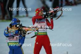 14.01.2009, Ruhpolding, Germany (GER): Sofia Domeij (SWE), Atomic, Leki, adidas and Chunli Wang (CHN), Fischer, Salomon, Swix, adidas  - IBU world cup biathlon, relay women, Ruhpolding (GER). www.nordicfocus.com. © Manzoni/NordicFocus. Every downloaded picture is fee-liable.