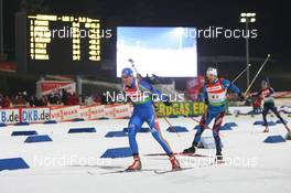 19.02.2009, Pyeong Chang, Korea (KOR): David Ekholm (SWE), Madshus, Rottefella, Alpina, Leki, adidas and Vincent Defrasne (FRA), Atomic, Rottefella, One Way, Odlo - IBU world championships biathlon, relay mixed, Pyeong Chang (KOR). www.nordicfocus.com. © Manzoni/NordicFocus. Every downloaded picture is fee-liable.