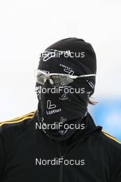 10.02.2009, Pyeong Chang, Korea (KOR): Michael Roesch (GER), Fischer, Rottefella, Exel, adidas, Toko hiding his face - IBU world championships biathlon, training, Pyeong Chang (KOR). www.nordicfocus.com. © Manzoni/NordicFocus. Every downloaded picture is fee-liable.