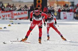 13.12.2009, Davos, Switzerland (SUI): Jovian Hediger (SUI), Rossignol, behind Nobu Naruse (JPN), Fischer, Rottefella  - FIS world cup cross-country, individual sprint, Davos (SUI). www.nordicfocus.com. © Hemmersbach/NordicFocus. Every downloaded picture is fee-liable.