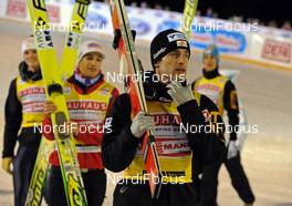 27.11.2009, Kuusamo, Finland (FIN): Wolfgang Loitzl (AUT), Atomic, leading the austrian team to flower ceremony - FIS world cup ski jumping, team HS142, Kuusamo (FIN). www.nordicfocus.com. © NordicFocus. Every downloaded picture is fee-liable.