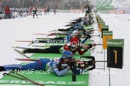 08.01.2010, Oberhof, Germany (GER): Svetlana Sleptsova (RUS), Madshus, Rottefella, Swix, adidas and Tim Burke (USA), Rossignol, Rottefella, Swix, adidas at the shooting range - IBU world cup biathlon, sprint women, Oberhof (GER). www.nordicfocus.com. © Manzoni/NordicFocus. Every downloaded picture is fee-liable.