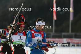 24.01.2010, Antholz, Italy (ITA): Martin Fourcade (FRA), Rossignol, Rottefella, Odlo and Arnd Peiffer (GER), Fischer, Salomon, Swix, adidas - IBU world cup biathlon, pursuit men, Antholz (ITA). www.nordicfocus.com. © Manzoni/NordicFocus. Every downloaded picture is fee-liable.