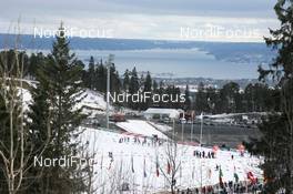21.03.2010, Holmenkollen, Norway (NOR): Overview from the top of the tracks over the start of the men's mass start and the ocean in the back - IBU world cup biathlon, mass men, Holmenkollen (NOR). www.nordicfocus.com. © Manzoni/NordicFocus. Every downloaded picture is fee-liable.