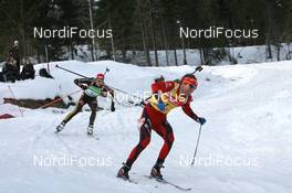 21.03.2010, Holmenkollen, Norway (NOR): Emil Hegle Svendsen (NOR), Madshus, Rottefella, Swix, Odlo leads Arnd Peiffer (GER), Fischer, Salomon, Swix, adidas - IBU world cup biathlon, mass men, Holmenkollen (NOR). www.nordicfocus.com. © Manzoni/NordicFocus. Every downloaded picture is fee-liable.