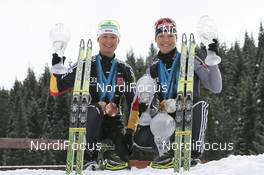 28.03.2010, Khanty-Mansiysk, Russia (RUS): Simone Hauswald (GER), Fischer, Rottefella, Exel, adidas, Toko and Magdalena Neuner (GER), Fischer, Rottefella, Exel, adidas - IBU world cup biathlon, cups, Khanty-Mansiysk (RUS). www.nordicfocus.com. © Manzoni/NordicFocus. Every downloaded picture is fee-liable.