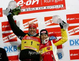 25.03.2010, Khanty-Mansiysk, Russia (RUS): Emil Hegle Svendsen (NOR), Madshus, Rottefella, Swix, Odlo and Magdalena Neuner (GER), Fischer, Rottefella, Exel, adidas - IBU world cup biathlon, cups, Khanty-Mansiysk (RUS). www.nordicfocus.com. © Manzoni/NordicFocus. Every downloaded picture is fee-liable.