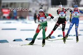 05.12.2010, Oestersund, Sweden (SWE): Darya Domracheva (BLR), Fischer, Rottefella, Swix leads Tina Bachmann (GER), Fischer, Rottefella, Swix, adidas  and Helena Ekholm (SWE), Fischer, Rottefella, Leki, adidas - IBU world cup biathlon, pursuit women, Oestersund (SWE). www.nordicfocus.com. © Manzoni/NordicFocus. Every downloaded picture is fee-liable.