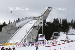 13.03.2010, Holmenkollen, Norway (NOR): start of the race, the new ski jumping stadium in the background - FIS world cup cross-country, 50km men, Holmenkollen (NOR). www.nordicfocus.com. © Hemmersbach/NordicFocus. Every downloaded picture is fee-liable.