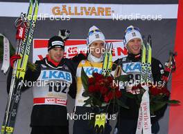 20.11.2010, Gaellivare, Sweden (SWE): Podium, l-r: 2nd Dario Cologna (SUI), Fischer, Rottefella, Alpina, Swix, Odlo, 1st Marcus Hellner (SWE), Fischer, Salomon, Exel, Craft and 3rd Daniel Rickardsson (SWE), Fischer, Salomon, Swix  - FIS world cup cross-country, 15km men, Gaellivare (SWE). www.nordicfocus.com. © Hemmersbach/NordicFocus. Every downloaded picture is fee-liable.