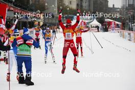 05.12.2010, Duesseldorf, Germany (GER): Feature, Maiken Caspersen Falla (NOR) celebrates her 2nd place Axel Teichmann (GER), Madshus, Rottefella, Swix, adidas, Toko the finish line. In the background, l-r: Arianna Follis (ITA), Fischer, Salomon, Swix and Celine Brun-Lie (NOR), Fischer, Rottefella, Alpina, Swix  - FIS world cup cross-country, team sprint, Duesseldorf (GER). www.nordicfocus.com. © Hemmersbach/NordicFocus. Every downloaded picture is fee-liable.