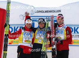 13.03.2010, Holmenkollen, Norway (NOR): podium overall world cup, l-r: Felix Gottwald (AUT), Jason Lamy-Chappuis (FRA), Fischer, Rottefella, Odlo, Magnus Moan (NOR), Madshus, Rottefella  - FIS world cup nordic combined, cups, Holmenkollen (NOR). www.nordicfocus.com. © Hemmersbach/NordicFocus. Every downloaded picture is fee-liable.