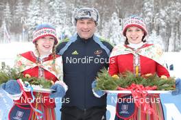 06.02.2011, Presque Isle, United States of America (USA): Jim Carrabre (CAN), IBU vice president responsible for medical issues  with flower girls - IBU world cup biathlon, pursuit women, Presque Isle (USA). www.nordicfocus.com. © Manzoni/NordicFocus. Every downloaded picture is fee-liable.
