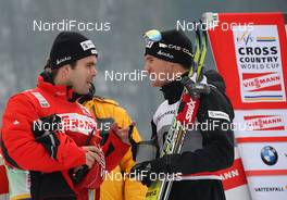 08.01.2011, Val di Fiemme, Italy (ITA): group, l-r: Christian Stahl (SUI), media coordinator swiss ski, Dario Cologna (SUI), Fischer, Rottefella, Alpina, Swix, Odlo  - FIS world cup cross-country, tour de ski, mass men, Val di Fiemme (ITA). www.nordicfocus.com. © Hemmersbach/NordicFocus. Every downloaded picture is fee-liable.