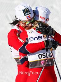 05.03.2011, Oslo, Norway (NOR): (l-r) Marit Bjoergen (NOR), Fischer, Swix, Rottefella congratulates the winner Therese Johaug (NOR), Fischer, Swix, Salomon  - FIS nordic world ski championships, cross-country, mass  women, Oslo (NOR). www.nordicfocus.com. © Laiho/NordicFocus. Every downloaded picture is fee-liable.