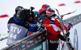04.03.2011, Oslo, Norway (NOR):  Eldar Roenning (NOR), Rossignol, Swix, Rottefella congratulated by a norwegian trainer in front of a tv camera  - FIS nordic world ski championships, cross-country, 4x10km men, Oslo (NOR). www.nordicfocus.com. © Laiho/NordicFocus. Every downloaded picture is fee-liable.
