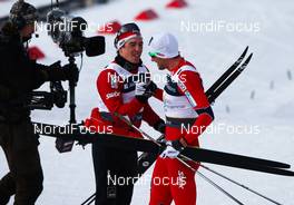 04.03.2011, Oslo, Norway (NOR):  (l-r) Eldar Roenning (NOR), Rossignol, Swix, Rottefella and Petter Northug (NOR), Fischer, Swix, Alpina, Rottefella, Skigo, while the tv broadcast the celebration - FIS nordic world ski championships, cross-country, 4x10km men, Oslo (NOR). www.nordicfocus.com. © Laiho/NordicFocus. Every downloaded picture is fee-liable.