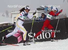 03.03.2011, Oslo, Norway (NOR): l-r: Anna Haag (SWE), Atomic, Salomon, One Way, Craft and Therese Johaug (NOR), Fischer, Salomon, Swix  - FIS nordic world ski championships, cross-country, 4x5km women, Oslo (NOR). www.nordicfocus.com. © Hemmersbach/NordicFocus. Every downloaded picture is fee-liable.