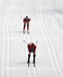 30.12.2011, Oberhof, Germany (GER): Justyna Kowalczyk (POL), Fischer, Rottefella, Swix in front of Marit Bjoergen (NOR), Fischer, Rottefella, Swix  - FIS world cup cross-country, tour de ski, pursuit women handicap start, Oberhof (GER). www.nordicfocus.com. © Hemmersbach/NordicFocus. Every downloaded picture is fee-liable.