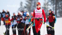 28.02.2011, Oslo, Norway (NOR):  Katerina Smutna (AUT), Fischer, One Way, Madshus, Rottefella, Loeffler looking NC-relay, on the background (r) the figure of Gregor Schlierenzauer (AUT) - FIS nordic world ski championships, nordic combined, team HS106/4x5km, Oslo (NOR). www.nordicfocus.com. © Laiho/NordicFocus. Every downloaded picture is fee-liable.