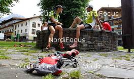 06.07.2011, Ehrwald, Austria (AUT): runners relaxing after the race at a fountain  - Salomon 4 Trails, trail running, 38km, Garmisch-Partenkirchen (GER) - Ehrwald (AUT). www.nordicfocus.com. Â© NordicFocus. Every downloaded picture is fee-liable.