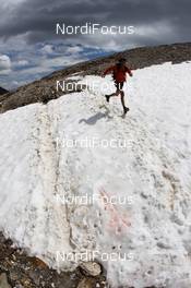 09.07.2011, Samnaun, Switzerland (SUI):  a runner crossing the snow - Salomon 4 Trails, trail running, 32km, Landeck (AUT) - Samnaun (SUI). www.nordicfocus.com. Â© NordicFocus. Every downloaded picture is fee-liable.