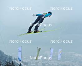 03.01.2011, Innsbruck, Austria (AUT): an athlete flying above flags - FIS world cup ski jumping, four hills tournament, individual HS130, Innsbruck (AUT). www.nordicfocus.com. Â© Felgenhauer/NordicFocus. Every downloaded picture is fee-liable.