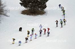 30.01.2011, Val di Fiemme / Val di Fassa, Italy (ITA): helicopter view, the chasing group, passing a photographer - FIS Marathon Cup Marcialonga, Val di Fiemme / Val di Fassa (ITA). www.nordicfocus.com. © Hemmersbach/NordicFocus. Every downloaded picture is fee-liable.