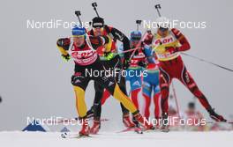 05.02.2012, Holmenkollen, Norway (NOR): Andreas Birnbacher (GER), Fischer, Rottefella, Alpina, Leki, adidas followed by Benjamin Weger (SUI), Atomic, Leki, Casco, ODLO  - IBU world cup biathlon, mass men, Holmenkollen (NOR). www.nordicfocus.com. Â© Laiho/NordicFocus. Every downloaded picture is fee-liable.