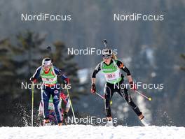 01.03.2012, Ruhpolding, Germany (GER): Elisa Gasparin (SUI), Rossignol, Rottefella, Leki, ODLO leads Sara Studebaker (USA), Rossignol, Rottefella, OneWay adidas - IBU world championships biathlon, relay mixed, Ruhpolding (GER). www.nordicfocus.com. © Manzoni/NordicFocus. Every downloaded picture is fee-liable.