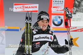 05.01.2012, Cortina-Toblach, Italy (ITA): todays winner Dario Cologna (SUI), Fischer, Rottefella, Alpina, Swix, Odlo  - FIS world cup cross-country, tour de ski, pursuit men, Cortina-Toblach (ITA). www.nordicfocus.com. © Hemmersbach/NordicFocus. Every downloaded picture is fee-liable.