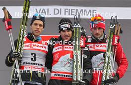 08.01.2012, Val di Fiemme, Italy (ITA): overall podium, l-r: Marcus Hellner (SWE), Fischer, Salomon, Exel, Craft, Dario Cologna (SUI), Fischer, Rottefella, Alpina, Swix, Odlo, Petter Northug (NOR), Fischer, Rottefella, Alpina, Ski Go, Swix   - FIS world cup cross-country, tour de ski, final climb men, Val di Fiemme (ITA). www.nordicfocus.com. © Hemmersbach/NordicFocus. Every downloaded picture is fee-liable.
