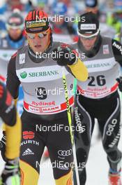 05.02.2012, Rybinsk, Russia (RUS): in front Jens Filbrich (GER), Rossignol, Rottefella, One Way, adidas, behind Remo Fischer (SUI), Fischer, Rottefella, Alpina, KV+, Odlo  - FIS world cup cross-country, skiathlon men, Rybinsk (RUS). www.nordicfocus.com. © Hemmersbach/NordicFocus. Every downloaded picture is fee-liable.