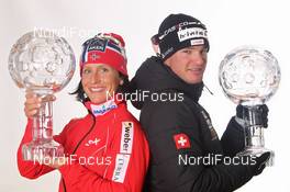 18.03.2012, Falun, Sweden (SWE): Overall World Cup Winners 2011/2012, l-r: Marit Bjoergen (NOR), Fischer, Rottefella, Swix and Dario Cologna (SUI), Fischer, Rottefella, Alpina, Swix, Odlo  - FIS world cup cross-country, cups, Falun (SWE). www.nordicfocus.com. © Hemmersbach/NordicFocus. Every downloaded picture is fee-liable.