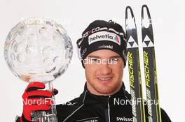18.03.2012, Falun, Sweden (SWE): World Cup Winner 2011/2012 and Distance World Cup Winner 2011/212 Dario Cologna (SUI), Fischer, Rottefella, Alpina, Swix, Odlo - FIS world cup cross-country, cups, Falun (SWE). www.nordicfocus.com. © Hemmersbach/NordicFocus. Every downloaded picture is fee-liable.