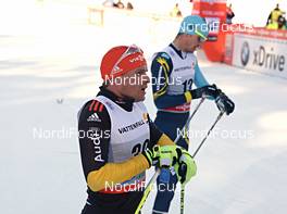03.01.2013, Cortina-Toblach, Italy (ITA): Tobias Angerer (GER) and Alexey Poltoranin (KAZ) check their watches - FIS world cup cross-country, tour de ski, pursuit men, Cortina-Toblach (ITA). www.nordicfocus.com. © Felgenhauer/NordicFocus. Every downloaded picture is fee-liable.