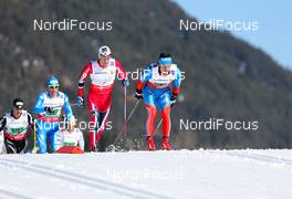 01.03.2013, Val di Fiemme, Italy (ITA): (l-r) Eldar Roenning (NOR), Rorrignol, Swix, Rottefella and Maxim Vylegzhanin (RUS), Fischer, Swix, Alpina, Rottefella, Adidas - FIS nordic world ski championships, cross-country, 4x10km men, Val di Fiemme (ITA). www.nordicfocus.com. © Laiho/NordicFocus. Every downloaded picture is fee-liable.