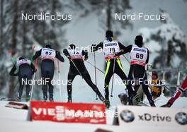 01.12.2013, Kuusamo, Finland (FIN): a group of racers passes Viessmann and BMW - FIS world cup cross-country, pursuit men, Kuusamo (FIN). www.nordicfocus.com. © Felgenhauer/NordicFocus. Every downloaded picture is fee-liable.