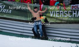 04.01.2013, Innsbruck, Austria (AUT): an austrian fan and a security man (AUT) celebrating Gregor Schlierenzauer´s victory after the competition  - FIS world cup ski jumping, four hills tournament, individual HS130, Innsbruck (AUT). www.nordicfocus.com. © Laiho/NordicFocus. Every downloaded picture is fee-liable.