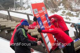 20.12.2013, Engelberg, Switzerland (SUI): Event Feature: Marshalls install the commerical board - FIS world cup ski jumping, training, Engelberg (SUI). www.nordicfocus.com. © Manzoni/NordicFocus. Every downloaded picture is fee-liable.