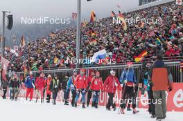 18.01.2015, Ruhpolding, Germany (GER): Jakov Fak (SLO) lead the athletes to the start along the grand stand - IBU world cup biathlon, mass men, Ruhpolding (GER). www.nordicfocus.com. © Manzoni/NordicFocus. Every downloaded picture is fee-liable.
