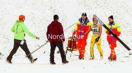 20.12.2015, Engelberg, Switzerland (SUI): Richard Freitag (GER) helped by the medics - FIS world cup ski jumping, individual HS137, Engelberg (SUI). www.nordicfocus.com. © Laiho/NordicFocus. Every downloaded picture is fee-liable.