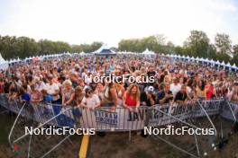 30.08.2024, Annecy, France (FRA): Event Feature: Fans with flags on the grandstand of the village  - Martin Fourcade Nordic Festival Biathlon, Annecy (FRA). www.nordicfocus.com. © Manzoni/NordicFocus. Every downloaded picture is fee-liable.