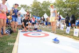 30.08.2024, Annecy, France (FRA): Event Feature: kid plays curling - Martin Fourcade Nordic Festival Biathlon, Annecy (FRA). www.nordicfocus.com. © Manzoni/NordicFocus. Every downloaded picture is fee-liable.