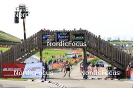 20.10.2024, Arcon, France (FRA): Undefined athletes compete under the stadium bridge - Biathlon Samse Summer Tour, pursuit, Arcon (FRA). www.nordicfocus.com. © Manzoni/NordicFocus. Every downloaded picture is fee-liable.