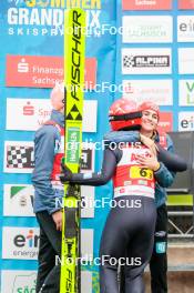 06.10.2024, Klingenthal, Germany (GER): Pius Paschke (GER), Katharina Schmid (GER), Selina Freitag (GER), (l-r)  - Summer Grand Prix ski jumping, mixed team HS140, Klingenthal (GER). www.nordicfocus.com. © Volk/NordicFocus. Every downloaded picture is fee-liable