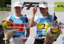 18.07.2024, Madona, Latvia (LAT): Flower ceremony,  Keidy Kaasiku (EST), Kaidy Kaasiku (EST),  - FIS Rollerski World Cup, team sprint, Madona (LAT). www.nordicfocus.com. © Koksarovs/NordicFocus. Every downloaded picture is fee-liable.